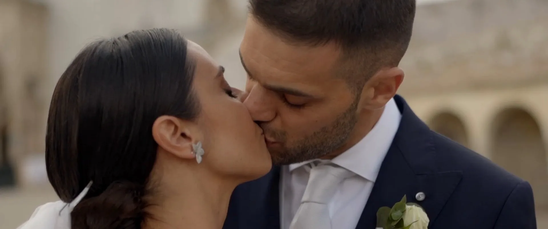 Giulia and Alessandro kissing in a square, a frame from their film