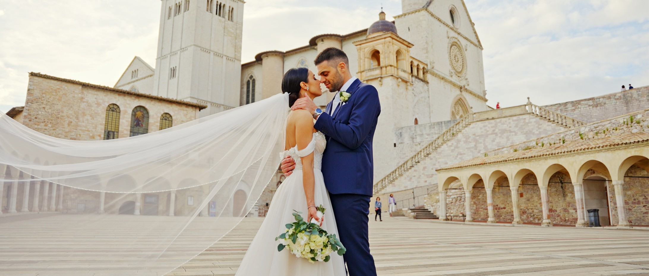 Giulia e Alessandro con la basilica di San Francesco d’Assisi sullo sfondo, fotogramma dal loro film