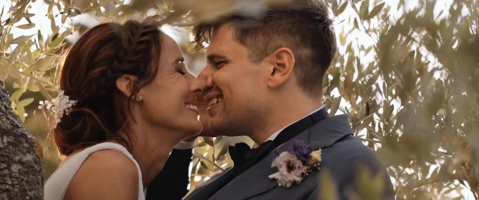 Rune and Cecilia nose to nose among the olive trees, a frame from their film