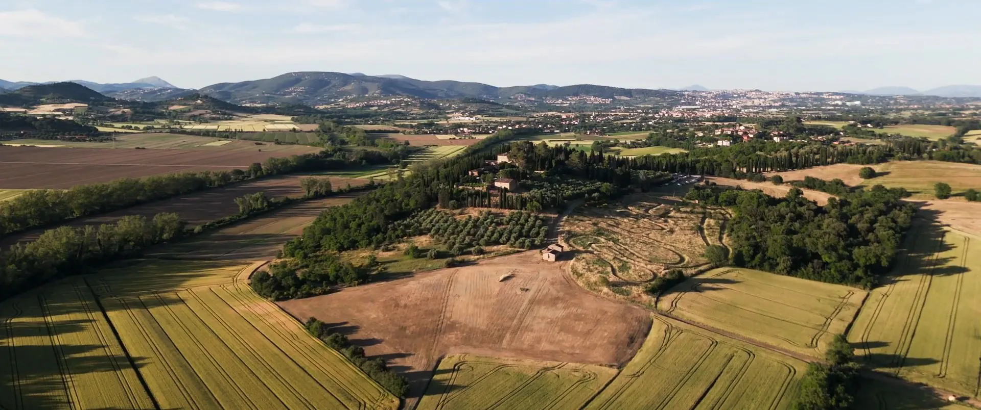 Umbrian hills and wheat fields seen from a drone, a frame from a Cinemarry film