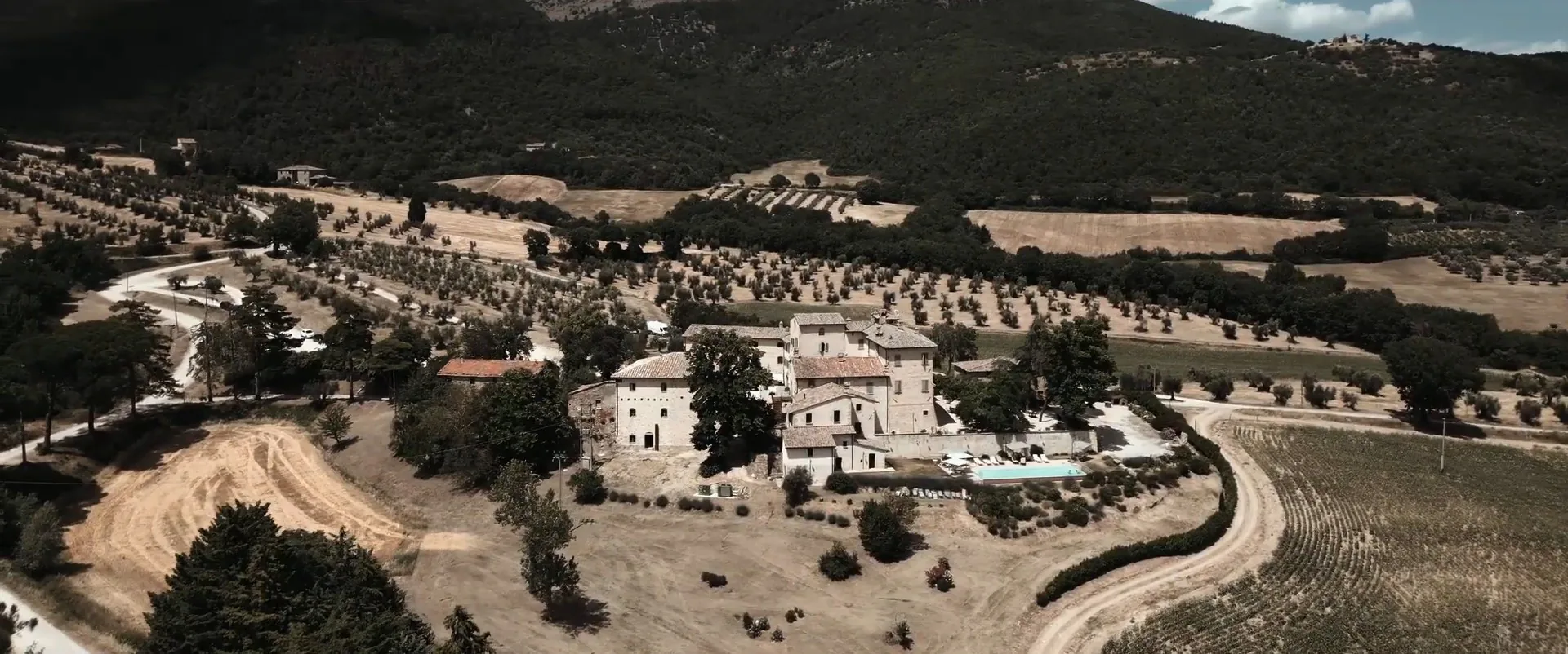 Borgo Colognola and the countryside in the hills around Perugia from a drone