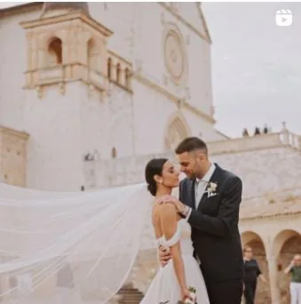 Couple in front of the Basilica of Saint Francis, veil in the wind — Cinemarry Instagram reel