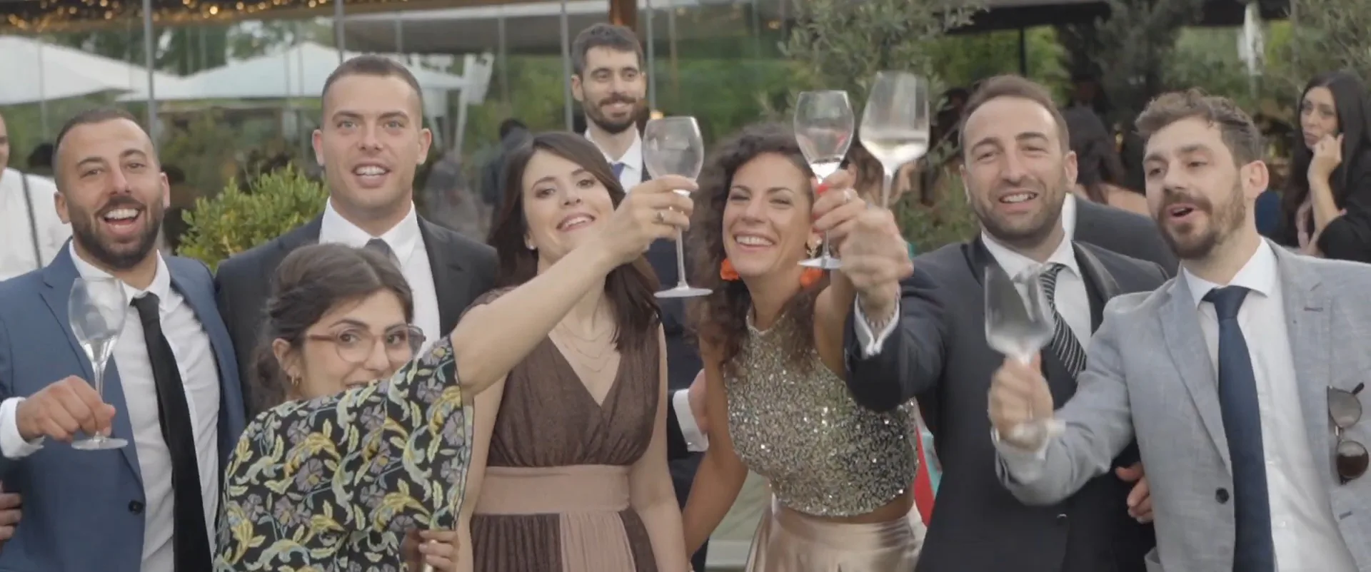 Wedding guests raising their glasses in a toast, a frame from a Cinemarry film