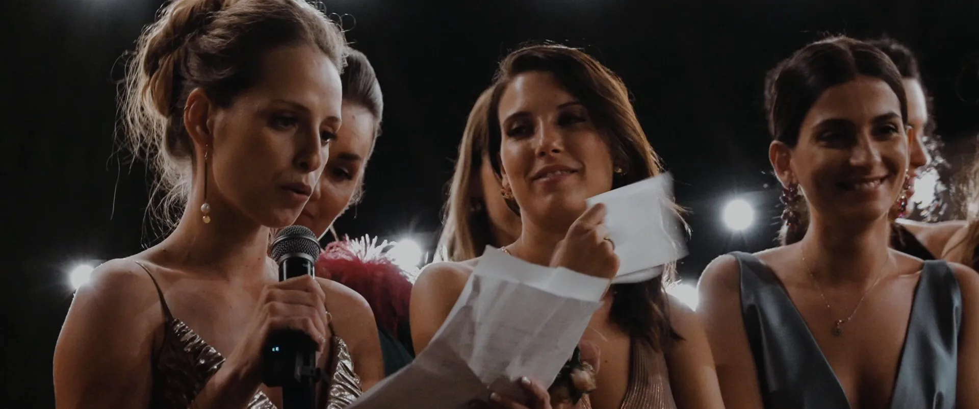 The bride’s friends reading their speech at the evening party